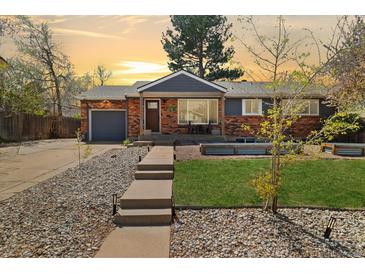 Charming brick home with a cozy front porch and well-maintained front yard landscaping at 882 E Briarwood Cir, Centennial, CO 80122