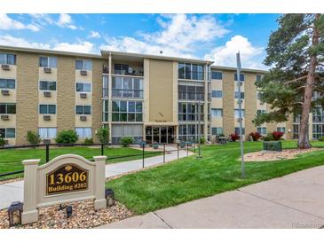 Well-maintained condo building with manicured lawn and visible signage for easy identification at 13606 E Bates Ave # 304, Aurora, CO 80014