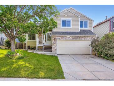 Charming two-story home featuring stone accents, neutral siding, and a well-maintained front yard at 11481 King St, Westminster, CO 80031