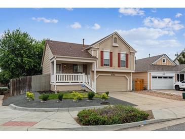 Charming two-story home with neutral siding, red shutters, and a well-manicured front yard at 4592 Malaya St, Denver, CO 80249