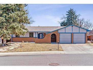 Charming single-story home featuring a brick facade, attached two-car garage, and mature trees at 3762 S Fenton Way, Denver, CO 80235