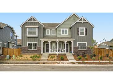 Charming duplex with a cozy front porch and well-maintained landscaping at 15277 Fillmore St, Thornton, CO 80602