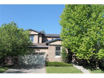 Charming two-story home featuring stone accents and a well-manicured front yard and an attached garage at 2601 Pemberly Ave, Highlands Ranch, CO 80126