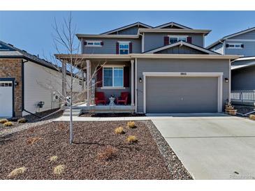 Charming two-story home with a well-manicured front yard and inviting front porch, perfect for relaxing outdoors at 3953 John Ave, Castle Rock, CO 80104