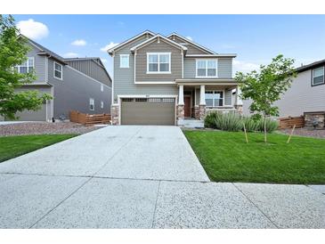 Charming two-story home with a well-manicured lawn, covered porch, and two car garage at 652 Pinecliff Dr, Erie, CO 80516