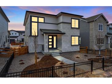 Charming two-story home showcasing modern design elements and well-maintained landscaping at 3336 N Haleyville Ct, Aurora, CO 80019