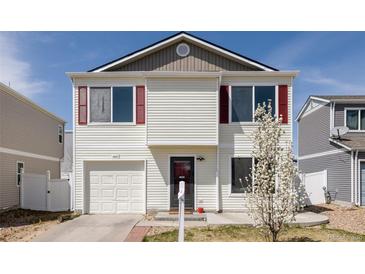 Charming two-story home featuring red shutters, vinyl siding, and an attached one car garage at 4555 Andes St, Denver, CO 80249