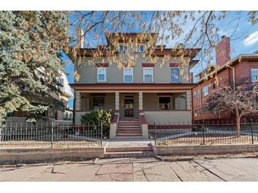 Charming three-story home featuring a covered front porch and mature trees at 1450 N High St # 3, Denver, CO 80218