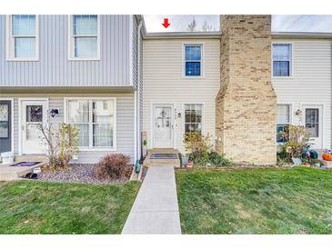 Charming townhome featuring well-maintained landscaping and a welcoming entrance at 8960 W Dartmouth Pl, Lakewood, CO 80227