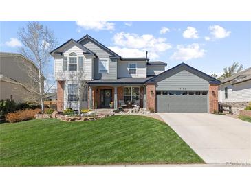 Charming two-story home with a well-manicured lawn, beautiful landscaping, and a spacious two-car garage at 7106 Cerney Cir, Castle Pines, CO 80108