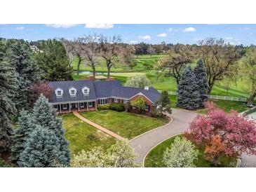 Stunning aerial view of home showcasing lush landscaping and golf course views at 10 Martin Ln, Cherry Hills Village, CO 80113