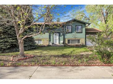 Charming home with a well-maintained lawn and mature trees, offering great curb appeal at 12829 E Oregon Dr, Aurora, CO 80012