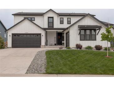 Beautiful two-story home featuring a well-manicured lawn, a two-car garage, and modern architectural design at 39405 Stockton Cir, Elizabeth, CO 80107