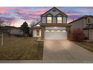 Charming two-story home with a well-manicured lawn and two-car garage, perfect for a growing Gathering at 5689 S Youngfield Way, Littleton, CO 80127