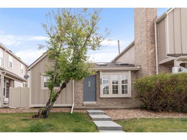 Charming townhome exterior with a well-manicured lawn and inviting entrance, showcasing lovely curb appeal at 9685 W Chatfield Ave # A, Littleton, CO 80128