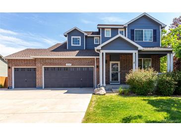 Charming two-story home featuring a three car garage, brick accents, and landscaped yard at 6694 E 129Th Ave, Thornton, CO 80602