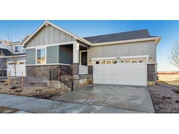 Modern two-story home with gray siding and a two-car garage at 1386 Bloom St, Brighton, CO 80601