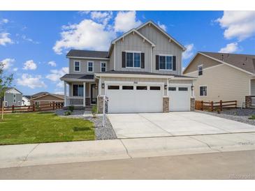 Inviting two-story home boasts a three-car garage, manicured lawn, and a charming covered porch at 7016 E 126Th Pl, Thornton, CO 80602