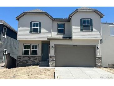 Charming two-story home with neutral siding, stone accents, and an attached two-car garage at 13342 Blue Amber Ct, Parker, CO 80134
