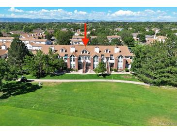 Townhome with a brick facade, mature trees and a green lawn in front at 3026 W Prentice Ave # G, Littleton, CO 80123