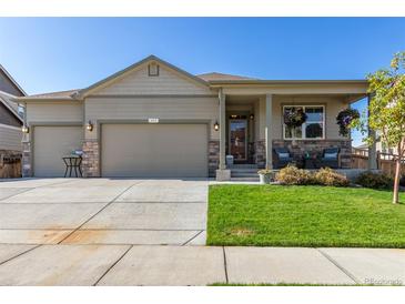 Charming single-story home featuring a well-manicured lawn and a two-car garage at 697 Gamble Oak St, Brighton, CO 80601