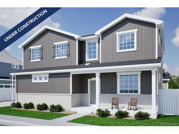 Charming two-story home with gray siding, white trim, covered porch, and attractive landscaping at 22363 E 38Th Pl, Aurora, CO 80019