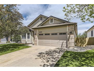 Charming home featuring a two-car garage, well-maintained lawn, and lovely curb appeal at 17059 Motsenbocker Way, Parker, CO 80134
