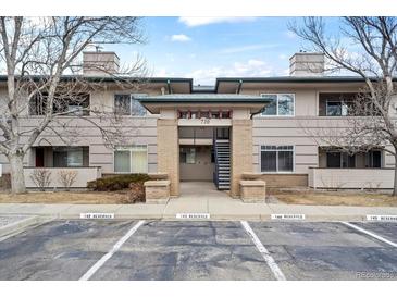 Inviting condo complex with covered entry and reserved parking spaces for residents and guests at 710 Copper Ln # 102, Louisville, CO 80027