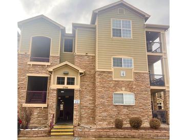 Three-story condo building with stone accents and multiple balconies at 17346 Nature Walk Trail Trl # 201, Parker, CO 80134