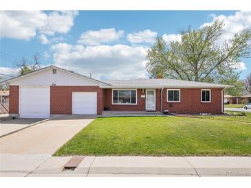Charming red brick ranch-style home featuring an attached two-car garage and a well-maintained lawn at 6086 W Arizona Ave, Lakewood, CO 80232