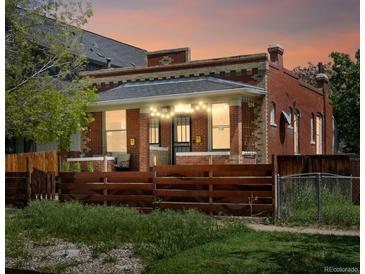 Charming brick home with a cozy front porch and a well-maintained fence at 3914 Osage St, Denver, CO 80211