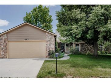 Charming single-Gathering home with a two-car garage, well-maintained lawn, and mature trees in a quiet neighborhood at 12631 W Dakota Dr, Lakewood, CO 80228