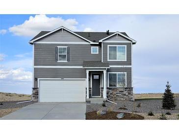 Two-story house with gray siding, white garage door, and stone accents at 43195 Merion Hills Ct, Elizabeth, CO 80107