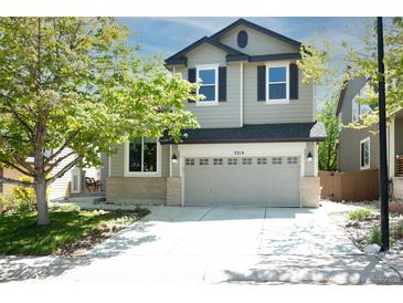 Charming two-story home featuring a well-maintained lawn, a two-car garage, and fresh landscaping at 3314 Astorbrook Cir, Highlands Ranch, CO 80126