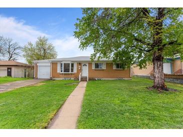 Charming single-story home with well-maintained lawn and beautiful landscaping at 690 W 1St Ave, Broomfield, CO 80020