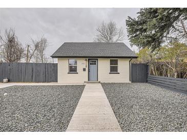 Charming exterior view of a single-story home featuring fresh paint, a gray roof, and a rock garden at 1525 Roslyn St, Denver, CO 80220