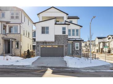 Two-story modern home with gray garage and snowy front yard at 8588 Eagle River St, Littleton, CO 80125
