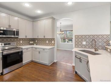 Modern kitchen with stainless steel appliances and stylish backsplash at 1428 S De Gaulle Ct, Aurora, CO 80018