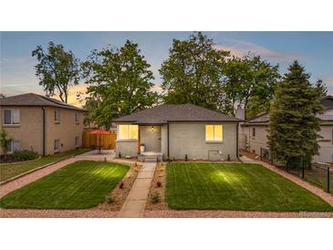 Charming home with a well-manicured lawn and a cozy patio area at 3541 Eudora St, Denver, CO 80207