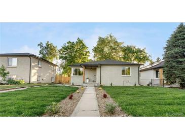 Charming exterior of this ranch-style home showcases a well-manicured lawn and inviting walkway at 3541 Eudora St, Denver, CO 80207