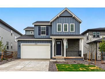 Charming two-story home with a two-car garage and a welcoming front porch at 7267 Prairie Sage Pl, Littleton, CO 80125
