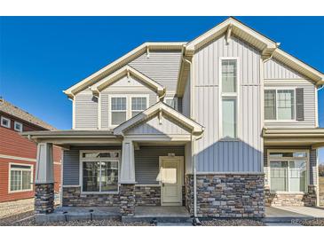 Beautiful two story home showcasing stone accents, stylish siding, and an inviting front porch at 17962 E 103Rd Ave, Commerce City, CO 80022