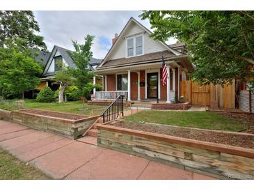 Charming brick home with a welcoming front porch and well-maintained landscaping at 482 S Logan St, Denver, CO 80209