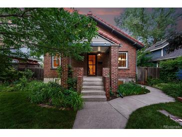 Charming brick home with a cozy front porch and well-maintained landscaping at 2232 S Ogden St, Denver, CO 80210