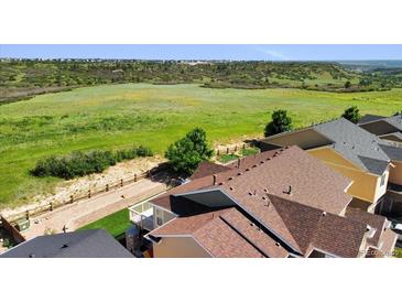 View of neighborhood with rolling hills, trails, and green spaces, with townhomes in the foreground at 3745 Spanish Oaks Trl, Castle Rock, CO 80108