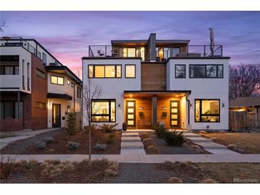 Modern two-story home with rooftop deck, eye-catching design, and professional landscaping at 2248 S Lincoln St, Denver, CO 80210