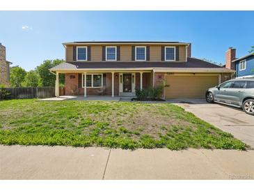 Charming two-story home with brick accents, a covered porch, and an attached two-car garage at 3285 W 11Th Avenue Ct, Broomfield, CO 80020