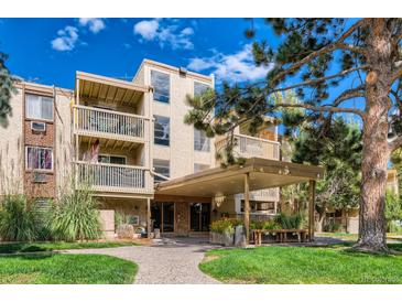 Inviting condo building with balconies, covered entrance and landscaped lawn on a sunny day at 1306 S Parker Rd # 162, Denver, CO 80231