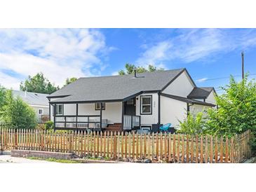 Charming home with a covered porch and a picket fence at 3275 W Hawthorne Pl, Denver, CO 80221