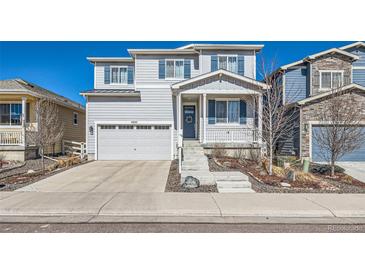 Charming two-story home with a well-manicured front yard and attached garage at 4327 Wilson Peak Dr, Castle Rock, CO 80104